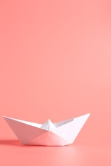 paper ship on a pink background.