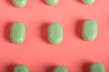 mint candy on a pink background. candy from a sore throat and cough