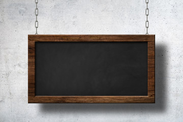 Large blackboard hanging on chains with concrete wall background © oxinoxi