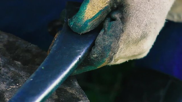 traditional iron forging, artisan sharpens a sharp knife blade with a hammer.