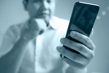 Businessman Holding and Using Smart Phone