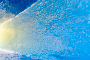 Background with rough texture of a wall painted blue and illuminated at sunset, with copy space to design banner with advertising.