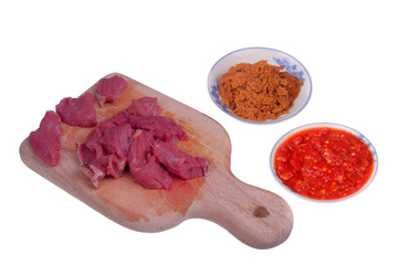 Appetizing red fresh veal, sliced into raw thin beef, chili and coconut fried or Kerisik  isolated   on white background