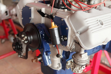 Front of a new big block engine inside an auto supply shop.