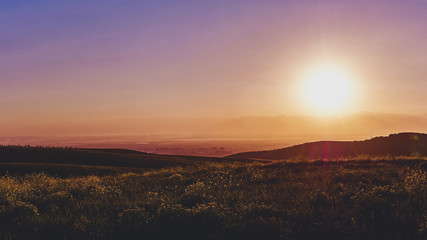 Panorama of a mountain valley in the summer. Fabulous sunset in the mountains, amazing nature, summer in the mountains. Travel and camping, tourism