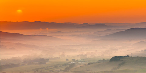 Tuscany orange foggy landscape scene