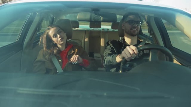 Young awesome woman listening to fav song. Couple in love spending time together, moving in rhythm of music. Enjoy. Weekend. Travel destination. Spring.