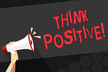 Fototapeta premium Text sign showing Think Positive. Business photo showcasing mental attitude in wich you expect good and favorable results Human Hand Holding Tightly a Megaphone with Sound Icon and Blank Text Space