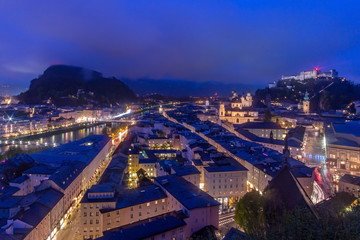 Fototapeta premium Beautiful view of Salzburg skyline with Festung Hohensalzburg and Salzach river at blue hour, Salzburger Land, Austria