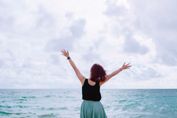 Obraz premium Woman rise hands up to sky freedom concept with blue sky.