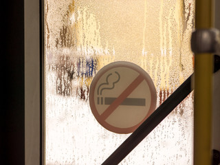 no smoking sign view from inside the bus