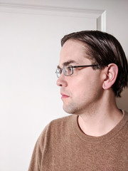 Obraz premium Portrait of Young Man in Glasses Looking into Frame