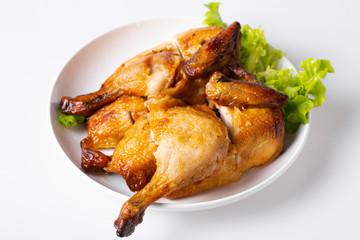 Chopped roasted chicken on white plate, isolated on white.