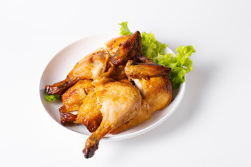 Chopped roasted chicken on white plate, isolated on white.