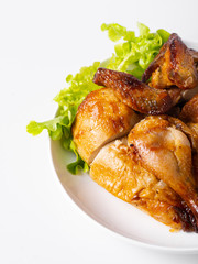 Chopped roasted chicken on white plate, isolated on white.