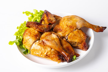 Chopped roasted chicken on white plate, isolated on white.