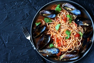 Pasta Spaghetti with mussels Marinara, tomato sauce. sea food meal. Typical dish of Italian pasta.  top view.
