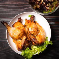 Chopped roasted chicken on wooden table.