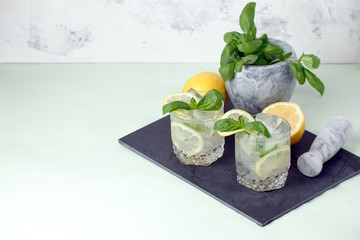 Basil, lemon lemonade or alcoholic cocktail with ice. Cold summer drink, resort bar menu, cafe concept