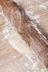 dough and wooden rolling pin close-up