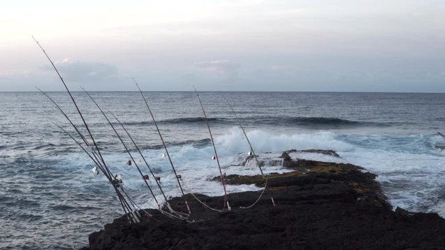 waves breaking while fishing for giant trevally or ulua in hawaii, captured in slow motion.
