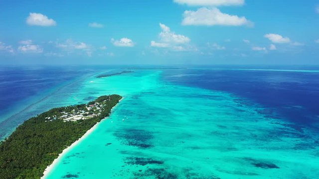 aerial footage of tropical island full of palms and crystal water around with clouds on thailand