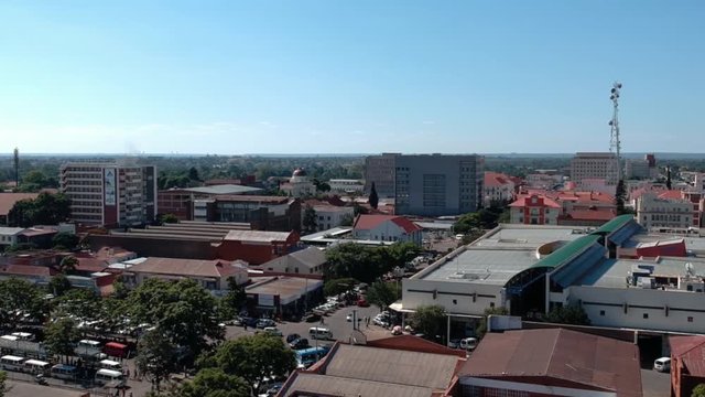 A panning drone shot of Bulawayo, Zimbabwe's city buildings under sunny conditions.