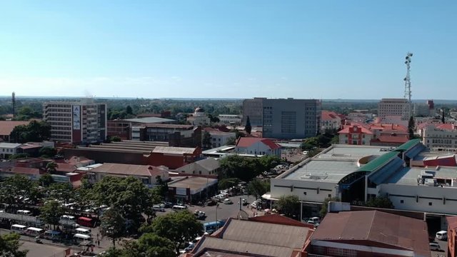 A panning drone shot of Bulawayo, Zimbabwe's city buildings under sunny conditions.