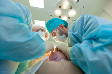Baldness treatment. Hair transplant. Surgeons in the operating room carry out hair transplant...