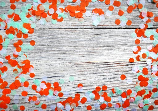 Three-color paper confetti on a white wooden background. Irish, india and Cinu, independence day concept. patriotism and freedom, the joy of the national holiday. horizontal