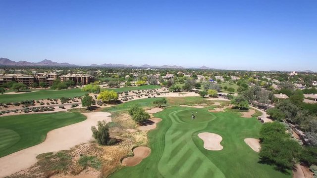 Aerial high angle of a foursome on the green, ​Scottsdale Arizona