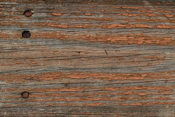 old wooden board with peeling brown paint abstract background