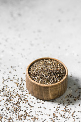Fototapeta na wymiar Chia seeds in a wooden bowl on a light background. For healthy nutrition