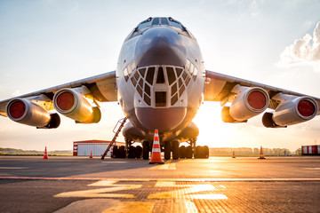 Wide body transport cargo aircraft at airport apron in the morning sun