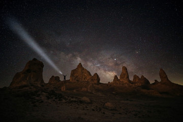 Fototapeta na wymiar Person Light Painted in the Desert Under the Night Sky