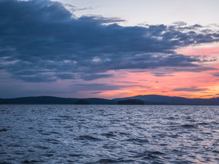 Obraz premium Calm, serenity, meditation concept. Sunset on the lake, quiet water, cloudless sky