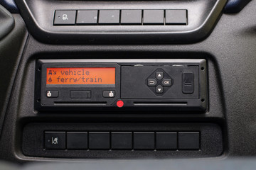 Digital tachograph display reads Vehicle Ferry Train. No personal data. Tachograph in a van
