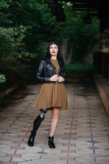A beautiful girl is disabled with a prosthesis on one leg.
