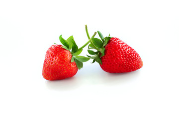 Two red strawberries of different shapes isolated on white background, closeup