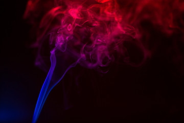 Fototapeta premium Colorful smoke close-up on a black background
