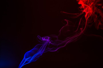 Fototapeta premium Colorful smoke close-up on a black background