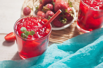 Glasses with fresh homemade strawberry sweet iced tea or cocktail, lemonade with mint. Refreshing cold drink. Summer pool party. Marine theme.