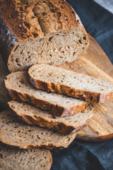 Rye bread with sunflower seeds on a wooden cutting board.