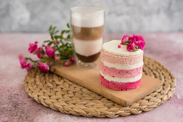 Naklejka premium Beautiful pink cream and berries cake on a light concrete background. Birthday celebration