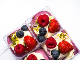 Yogurt desert with raspberries, blackberry, strawberry and nuts
