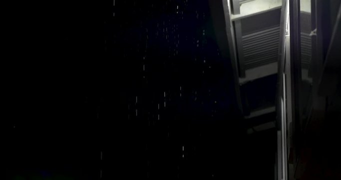 rain dripping off roof line of a Hawaiian house on the big island, rain reflecting the white light.