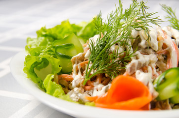 salad of boiled beef, champignons, carrots, pickled cucumbers, onions and lettuce seasoned with mayonnaise