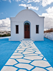 Blue and white path leading to small chapel, Milos island, Greece.