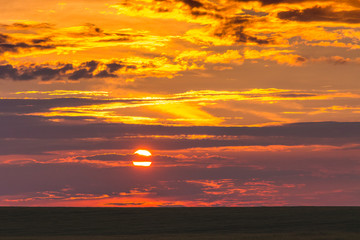 Scenic sky with clouds during the sunset in the field_