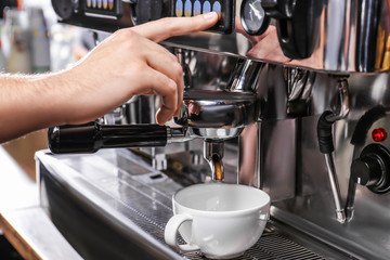 Barista preparing fresh aromatic coffee in cafe